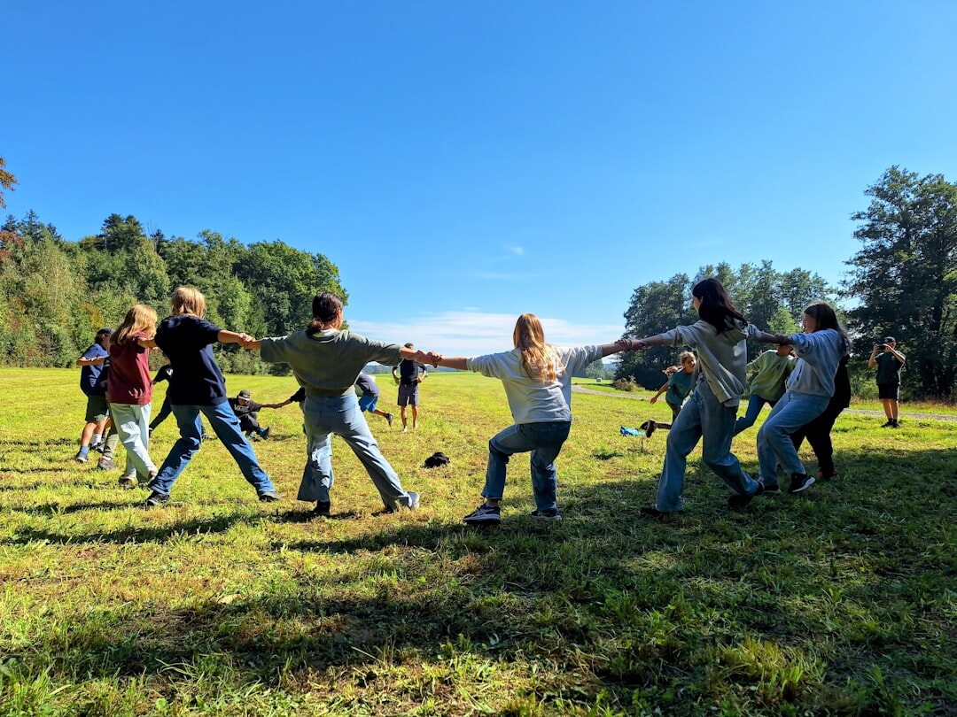 Large group of employees gathered for an outdoor team building event in the Belgian countryside